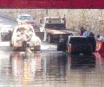 Hallan camioneta inundada en puente
